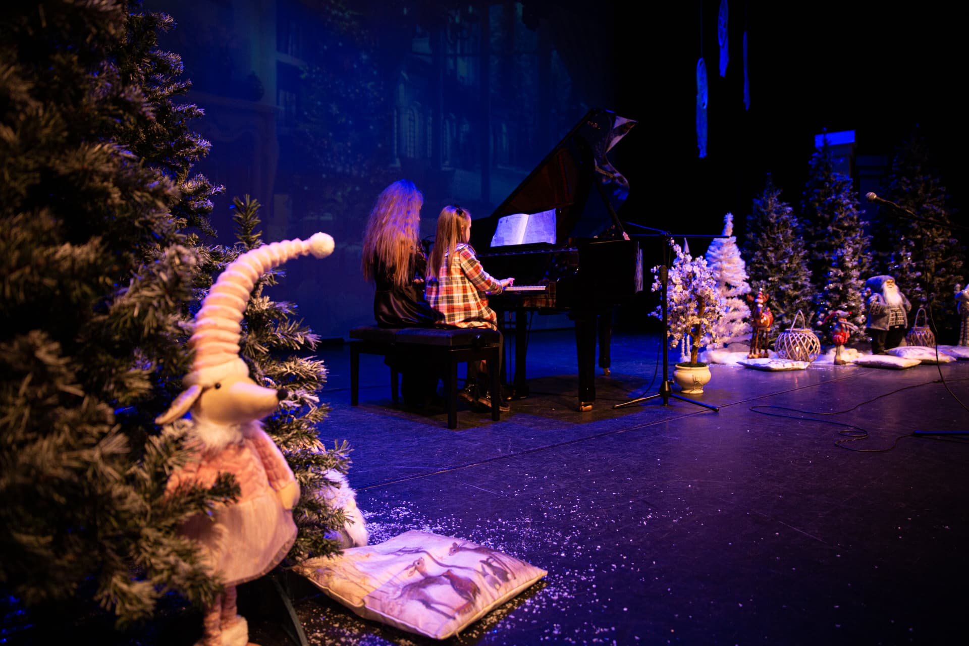 Student performing piano on stage