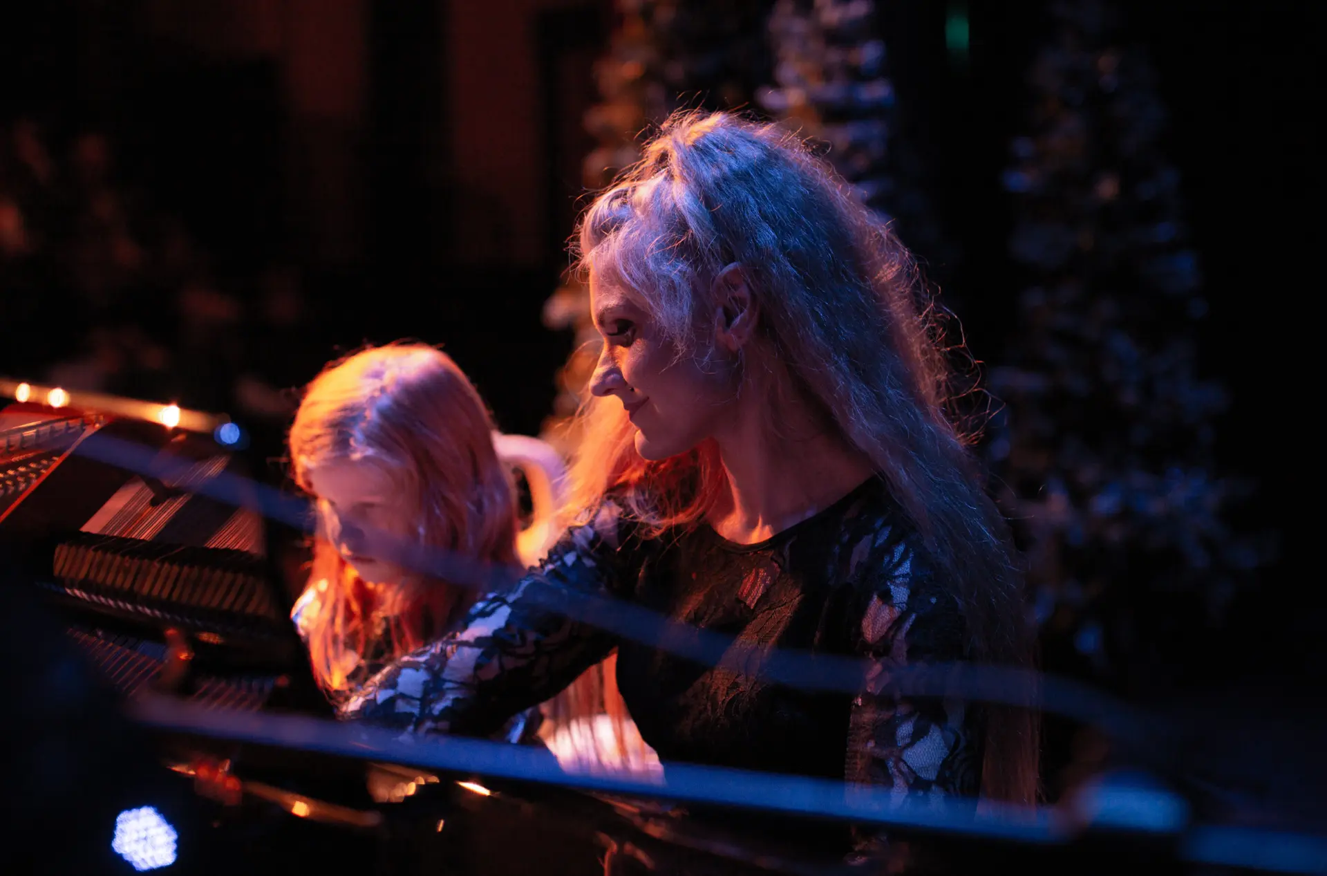 Vilma supporting a student during a piano performance