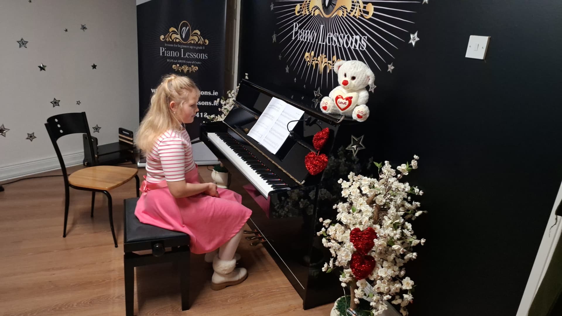 Young student playing piano during a lesson