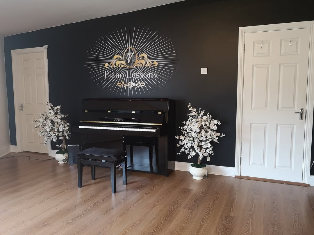 Piano and V. Piano Lessons wall emblem in the teaching room